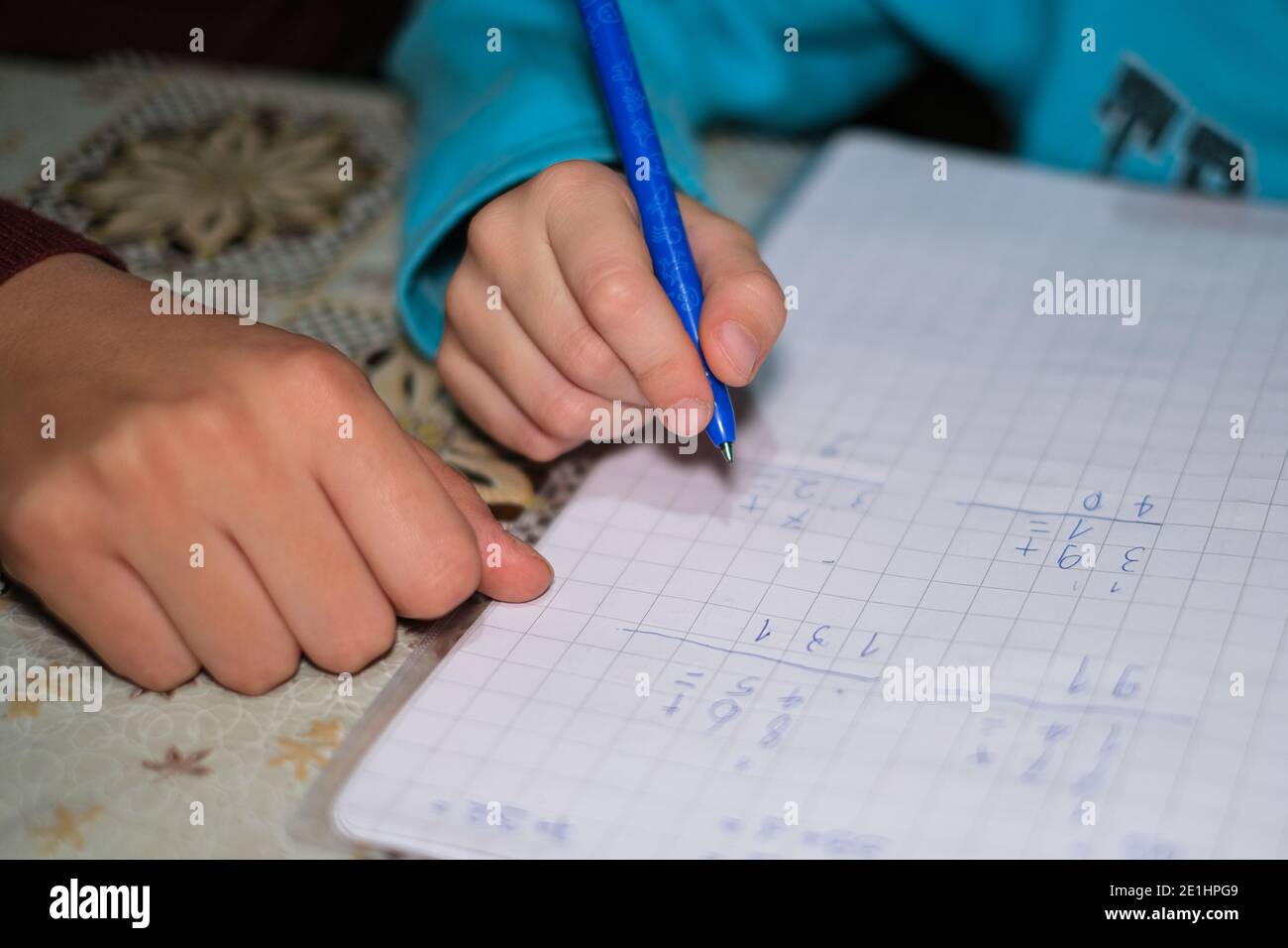 Woman teach son how to do maths homework at home,school child support education Stock Photo