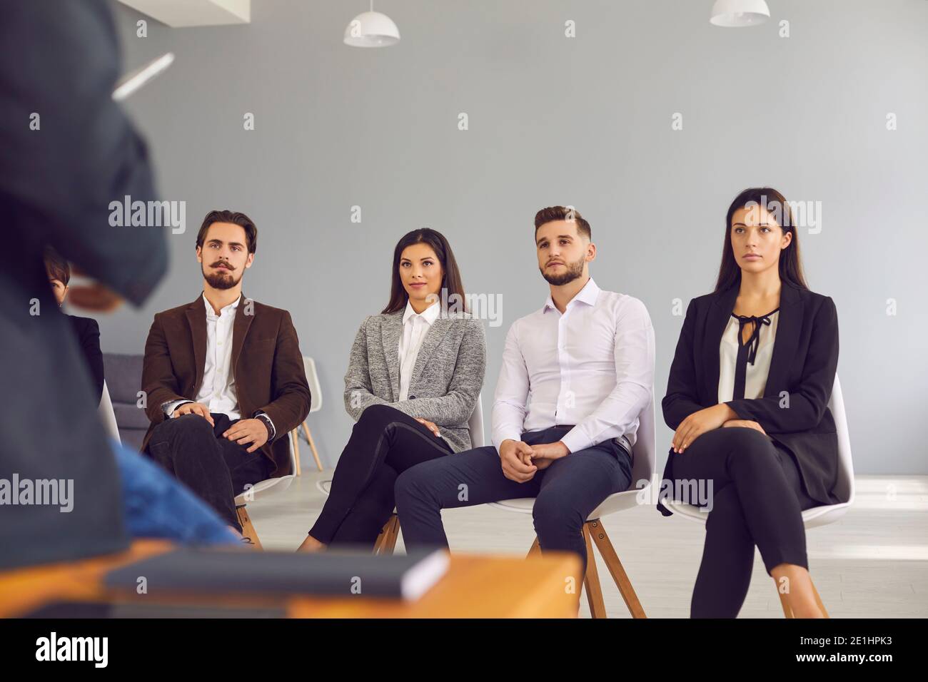 Group of company workers listening to businessman or executive manager making presentation or training Stock Photo