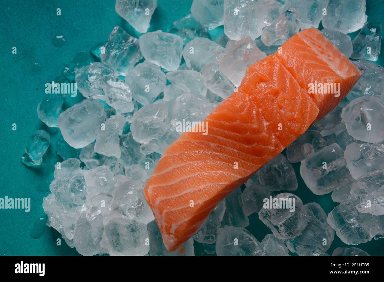 Raw salmon steaks on ice background Stock Photo - Alamy