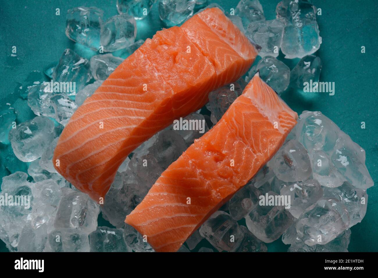 Raw salmon steaks on ice background Stock Photo - Alamy