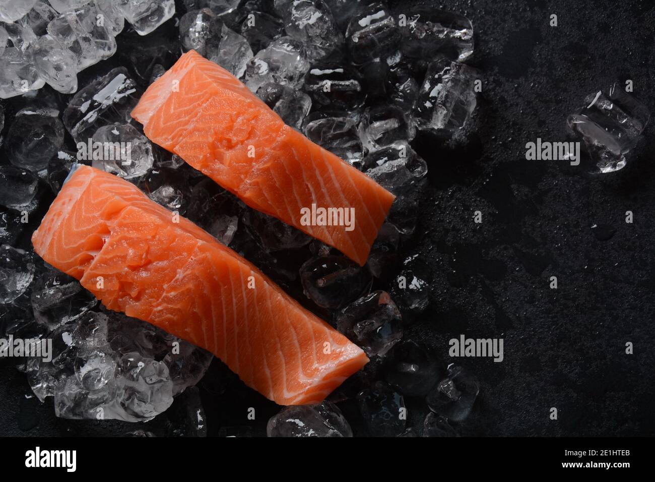 Raw salmon steaks on ice background Stock Photo - Alamy