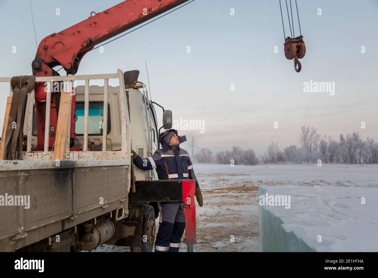 Portrait of a hydraulic crane operator loading ice panels Stock Photo