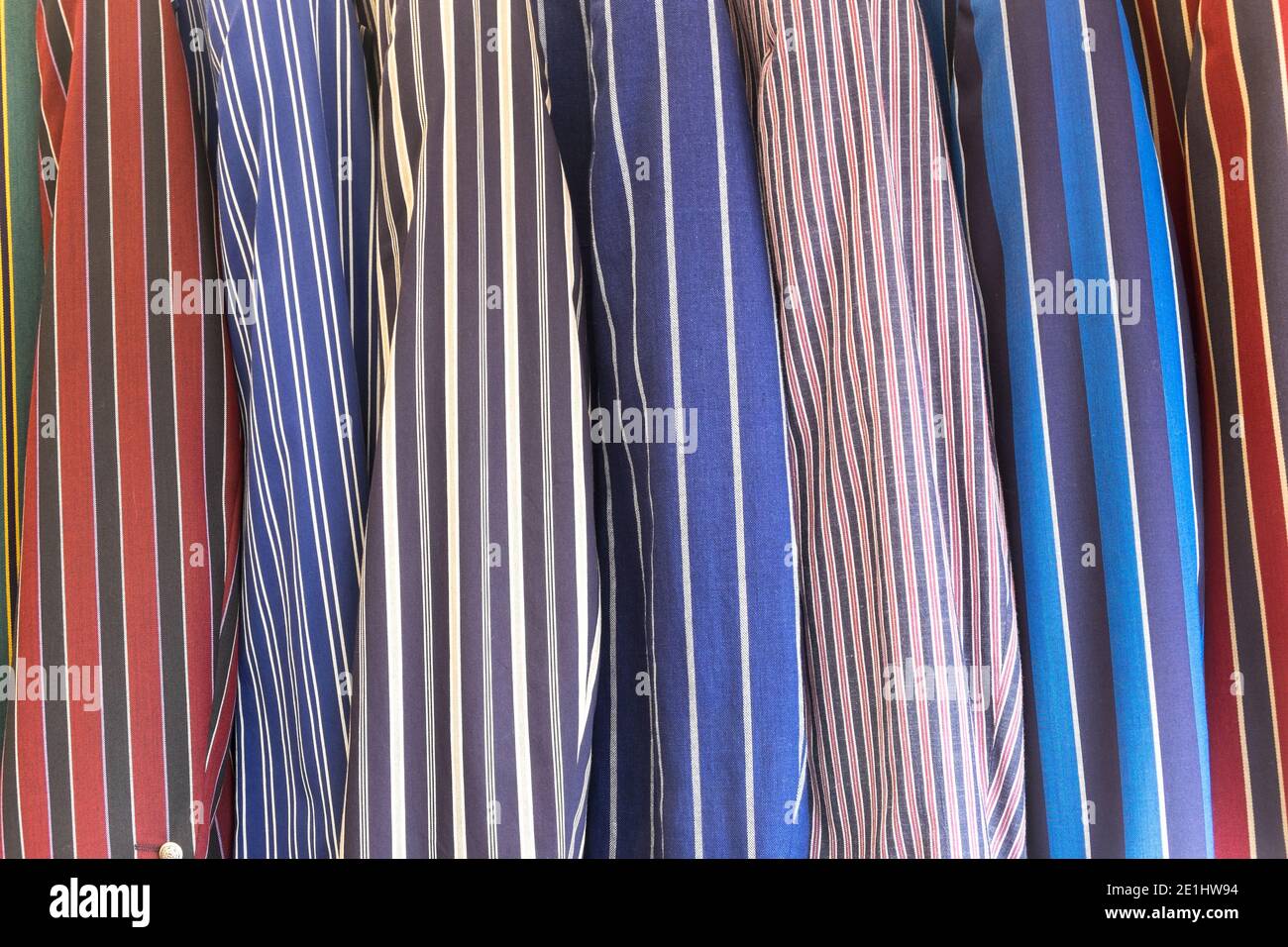 A selection of striped blazers on a rack, traditional leisure wear. Stock Photo