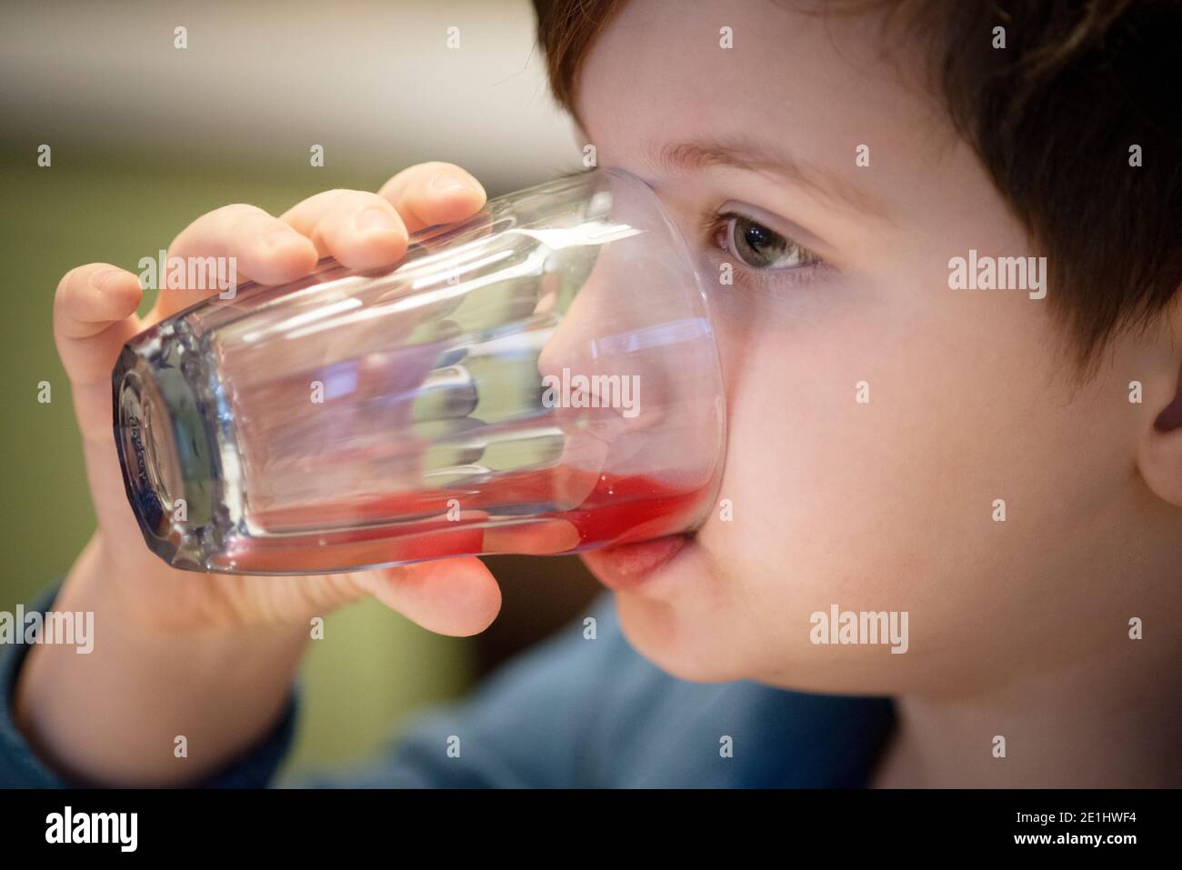 Boy Drinking Orange from Glass Stock Photo