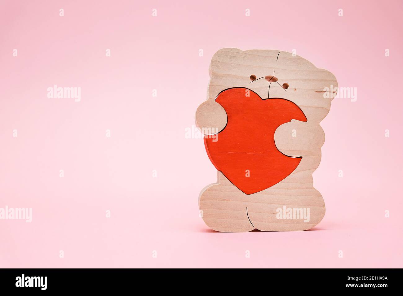 Valentines Day background. Cute teddy Bear toy with red heart on pink ...