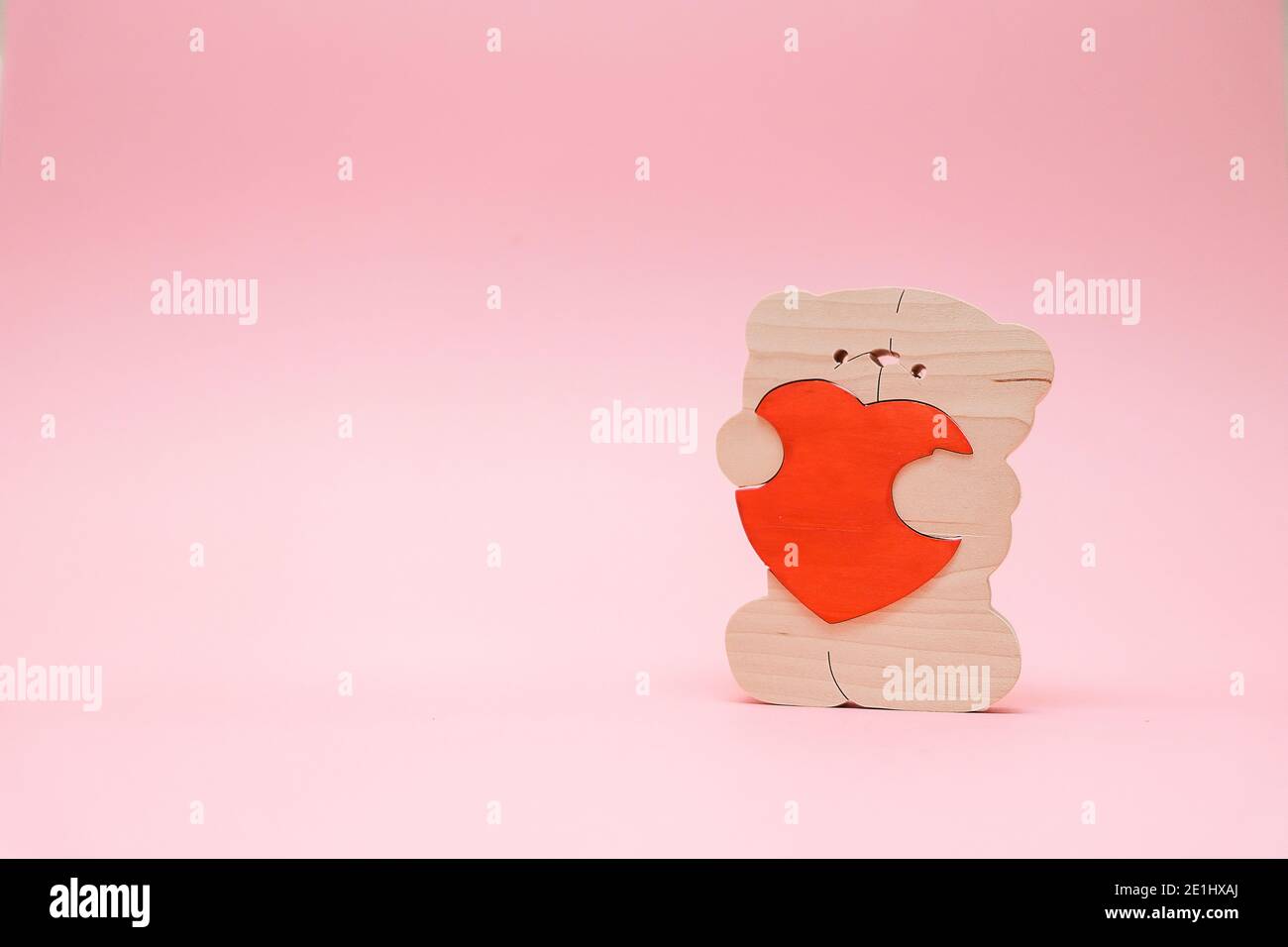 Valentines Day background. Cute teddy Bear toy with red heart on pink ...