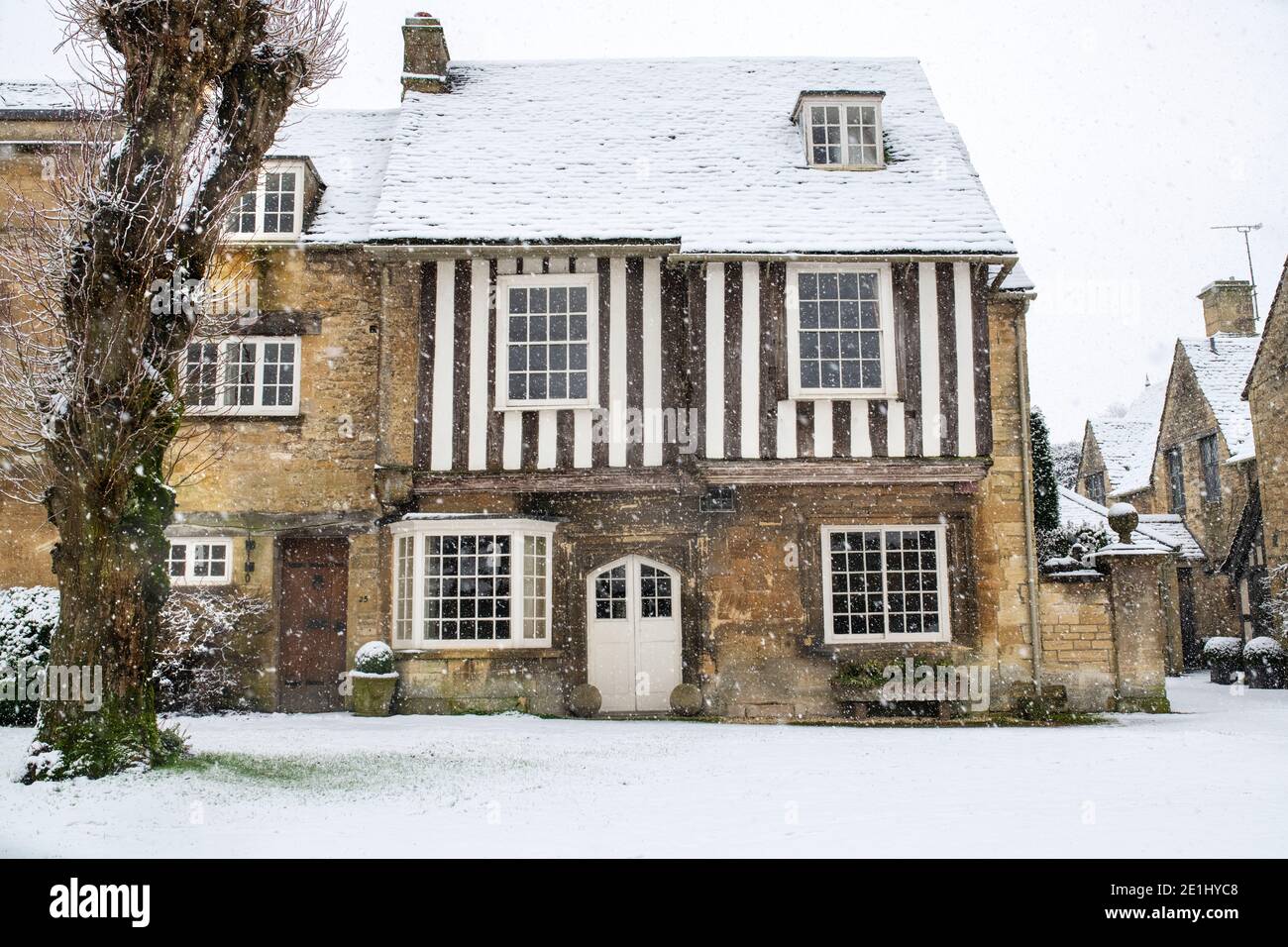 Stone and timber framed house in the December snow. Sheep street,  Burford, Cotswolds, Oxfordshire, England Stock Photo