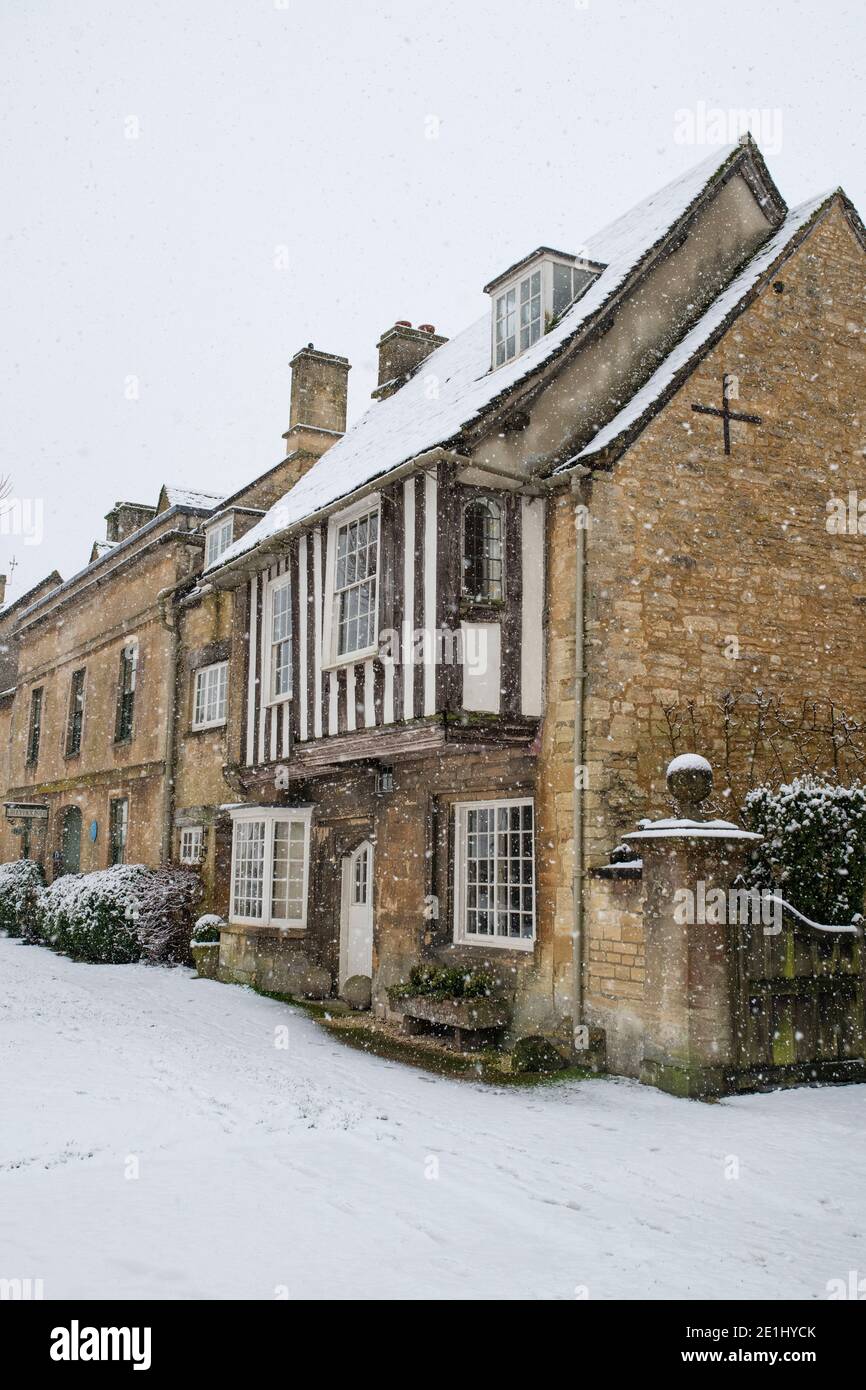 Stone and timber framed house in the December snow. Sheep street,  Burford, Cotswolds, Oxfordshire, England Stock Photo