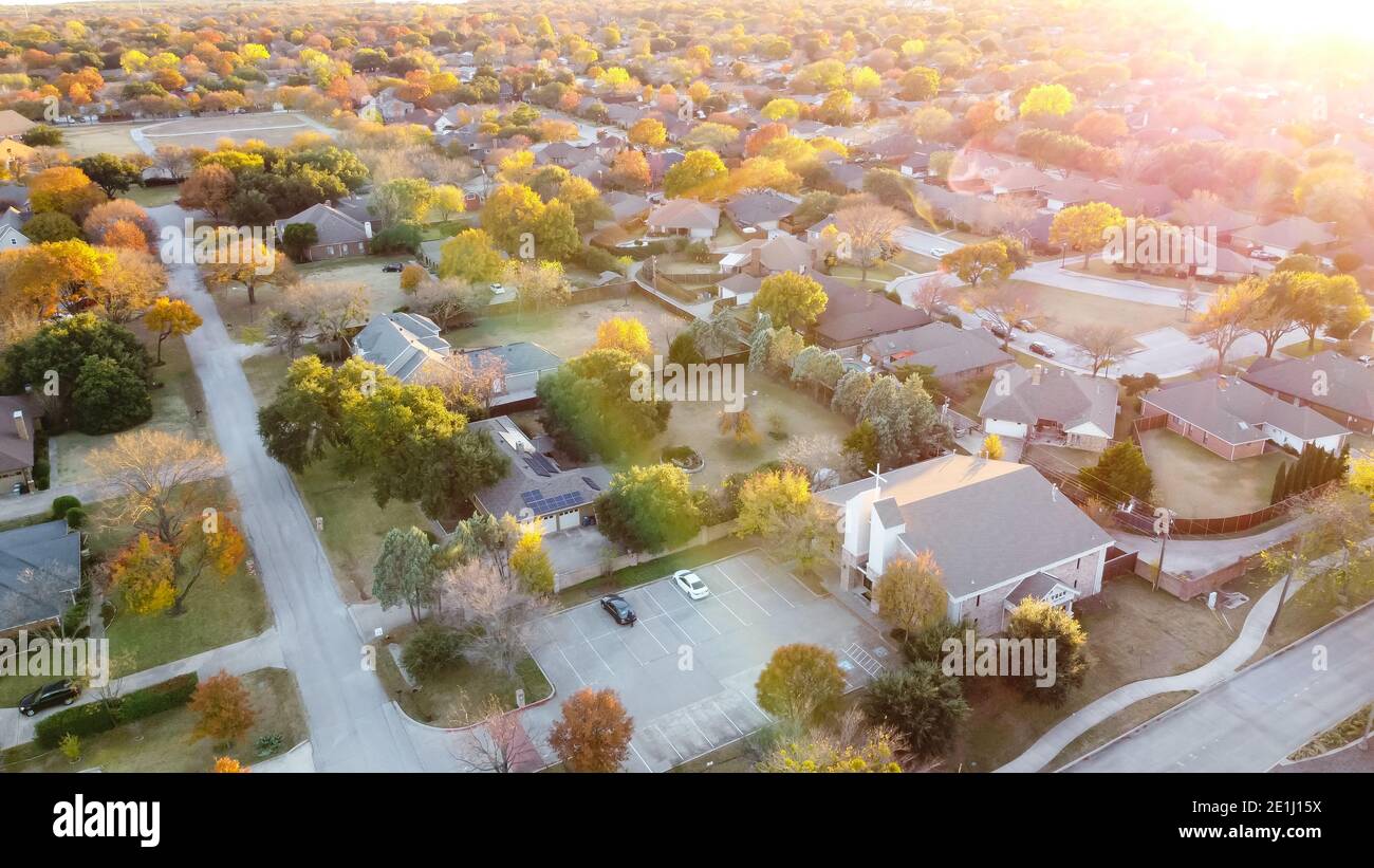 Aerial view suburban church near residential neighborhood at sunset