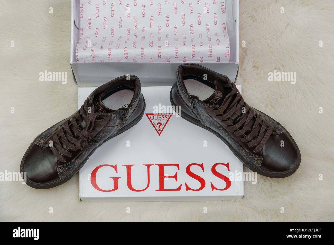 Guess shoes online delivery box display. Open carton order package  containing pair of wearables by famous clothing brand with company logo  Stock Photo - Alamy