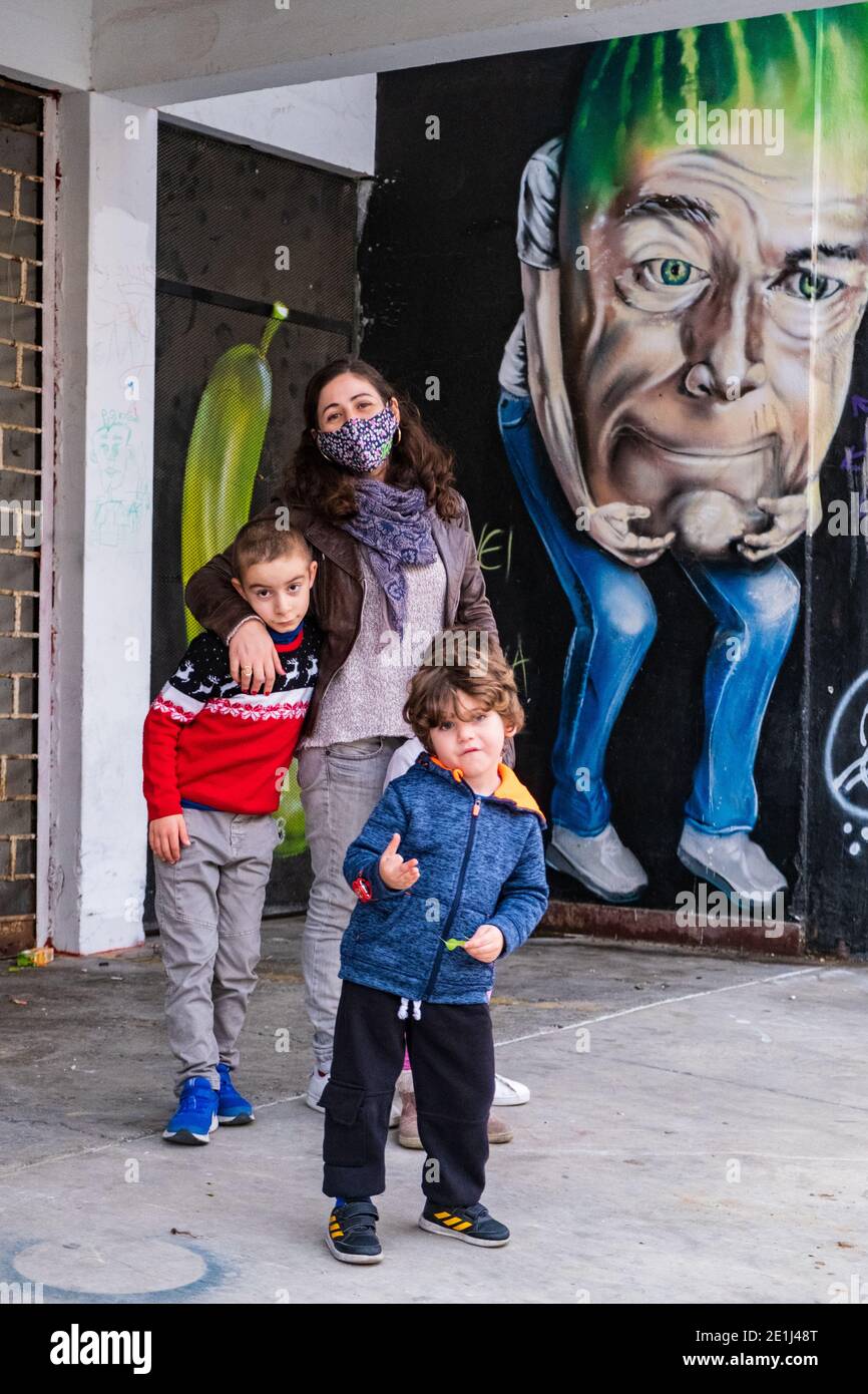 Nicosia, Cyprus - December 9, 2020: A mother and her children pose at the entrance to the abandoned old Municipal Market building of Nicosia in the ol Stock Photo