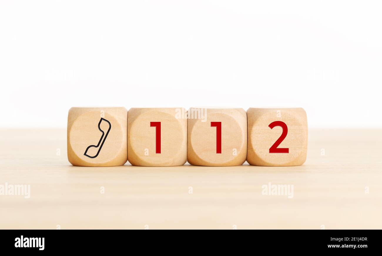 112 emergency concept. Wooden dices with phone icon and 112 text. Copy space white background Stock Photo