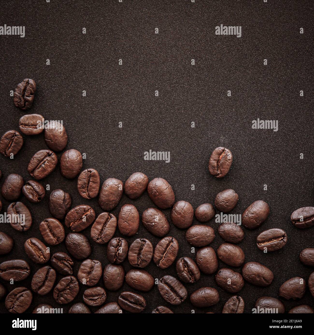 Roasted coffee beans on black paper background Stock Photo - Alamy