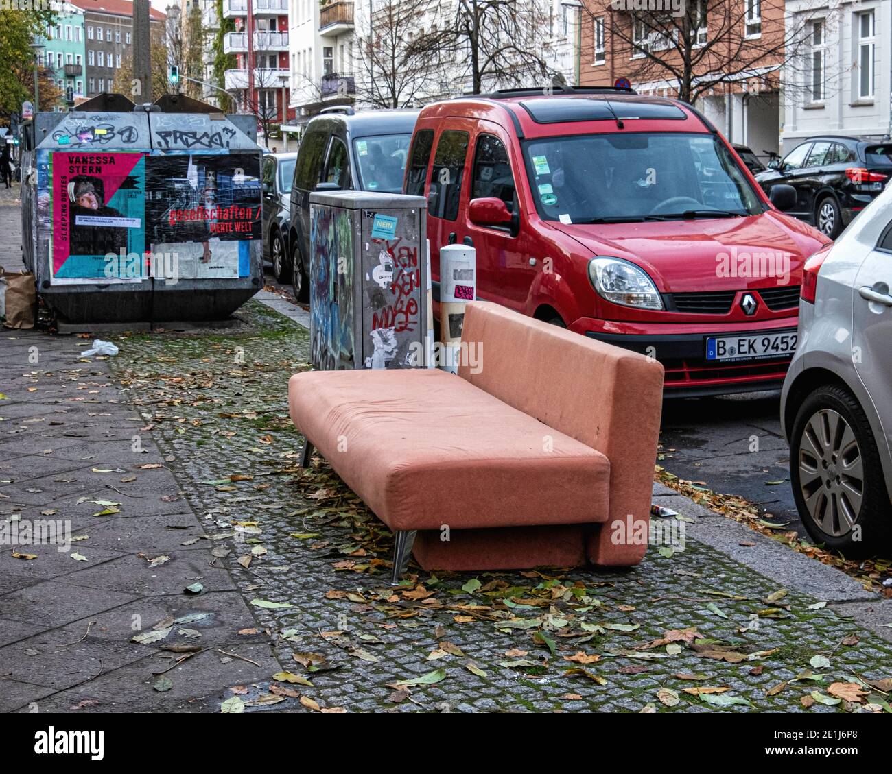 Pink sofa bed, couch, abandoned & dumped on an urban pavement,Prenzlauer Berg ,Berlin, Germany Stock Photo