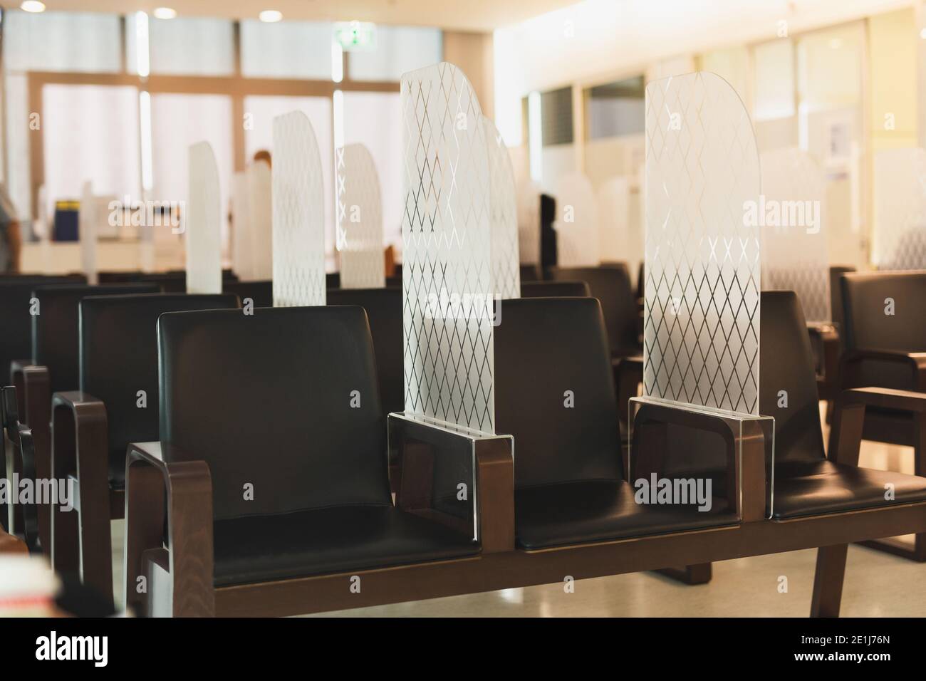 Social Distancing chair with Acrylic partition in waiting room during covid-19. Stock Photo
