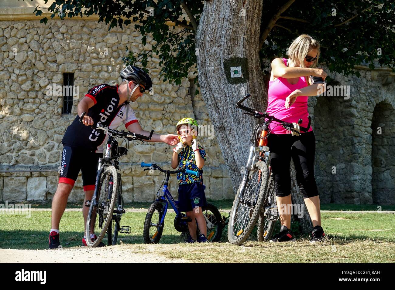 Family lifestyle Man woman child on bike trip Family cycling Summer vacation Stock Photo