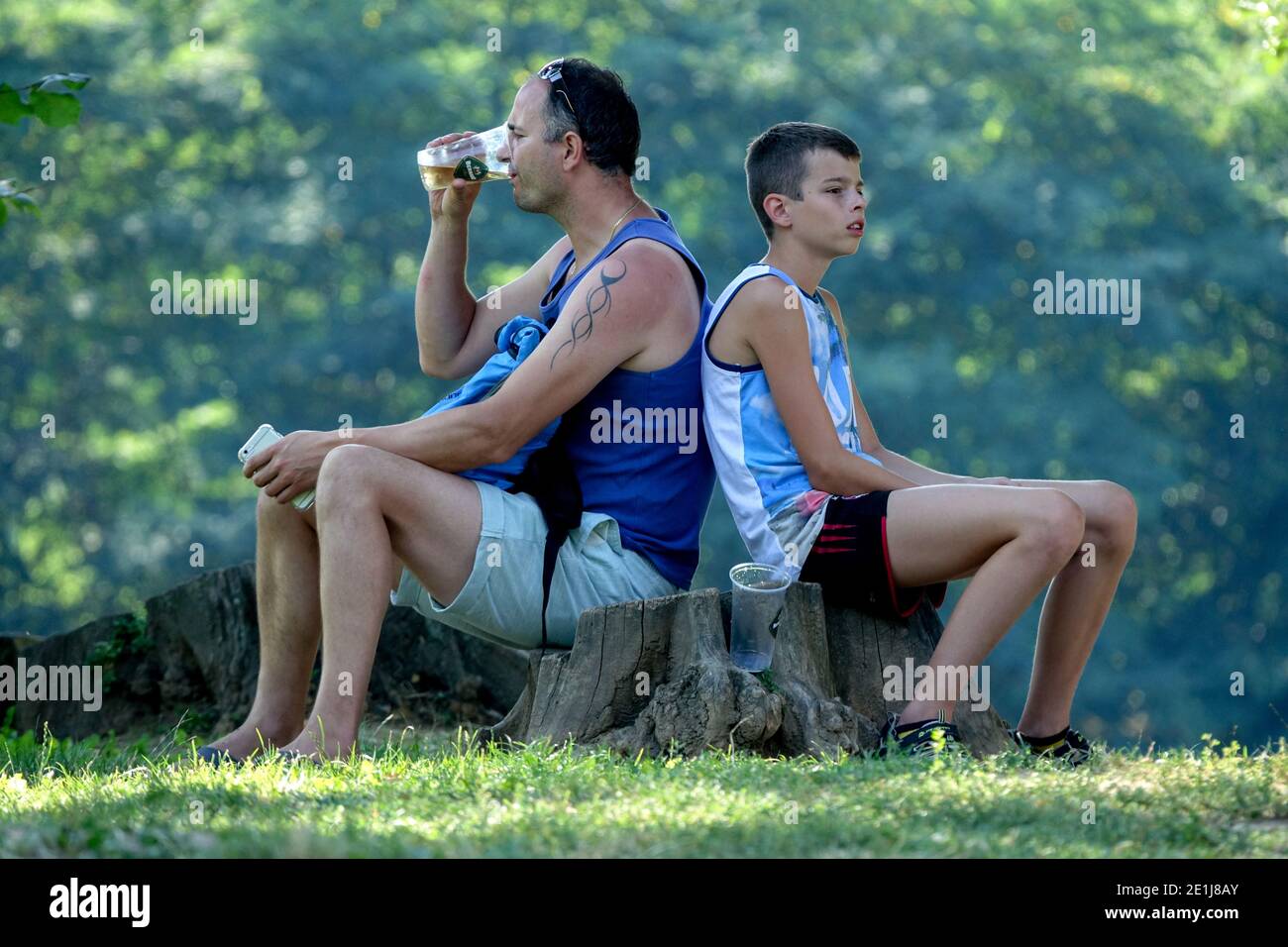 Father and son on trip Man drinking beer Stock Photo