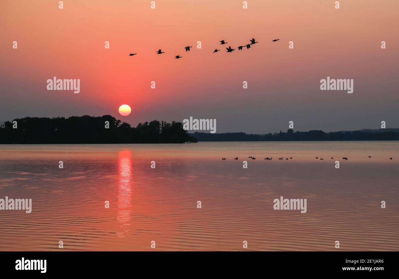 Sunsets in Malente am Dieksee are particularly romantic because you can watch this natural spectacle particularly well. Stock Photo