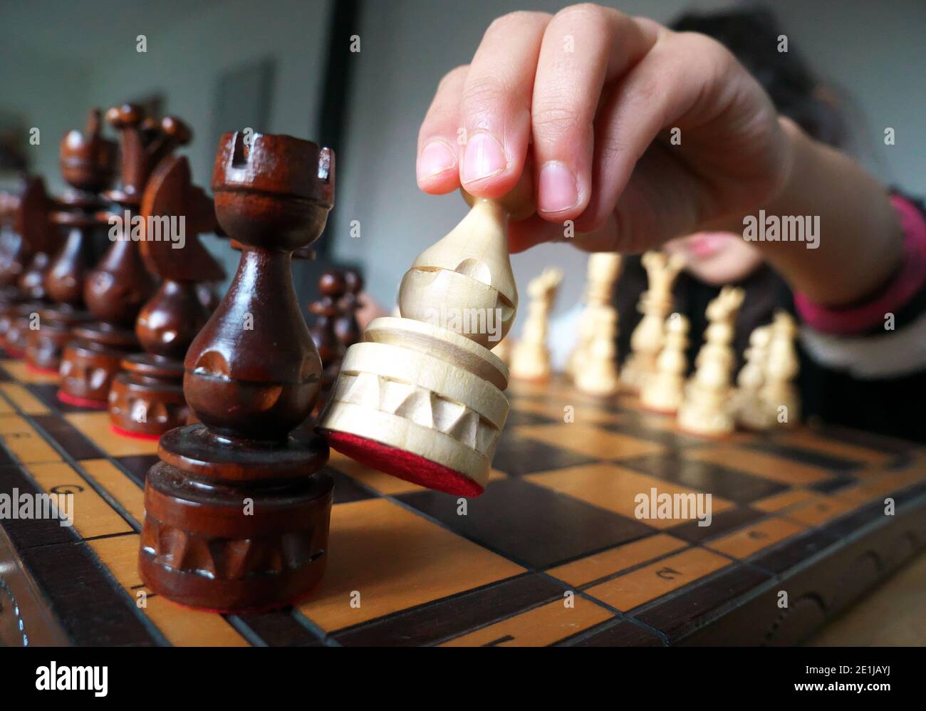 Close-up of a player's hand moving the pieces of a chess game Stock ...