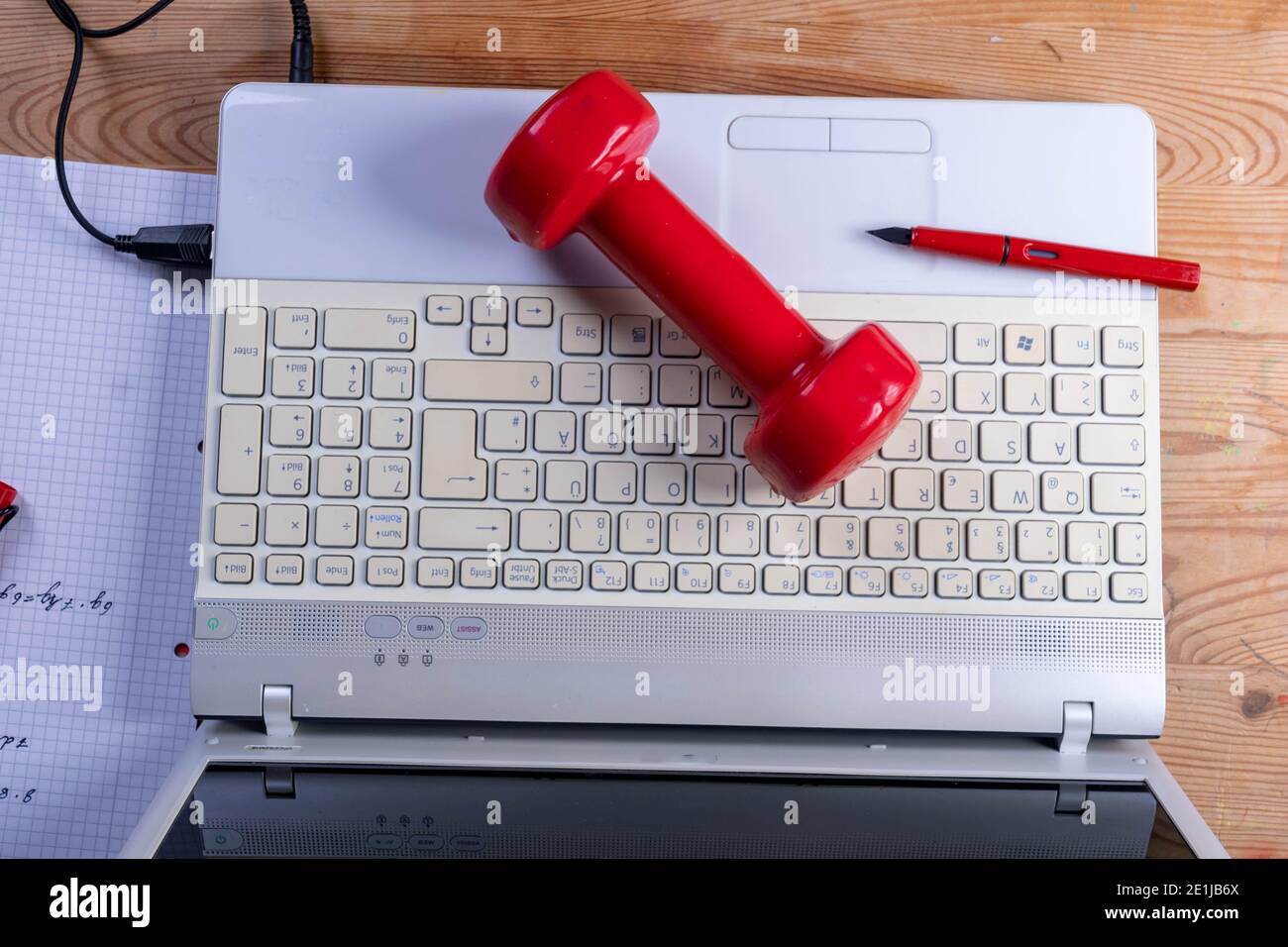 red dumbbell on a laptop Stock Photo
