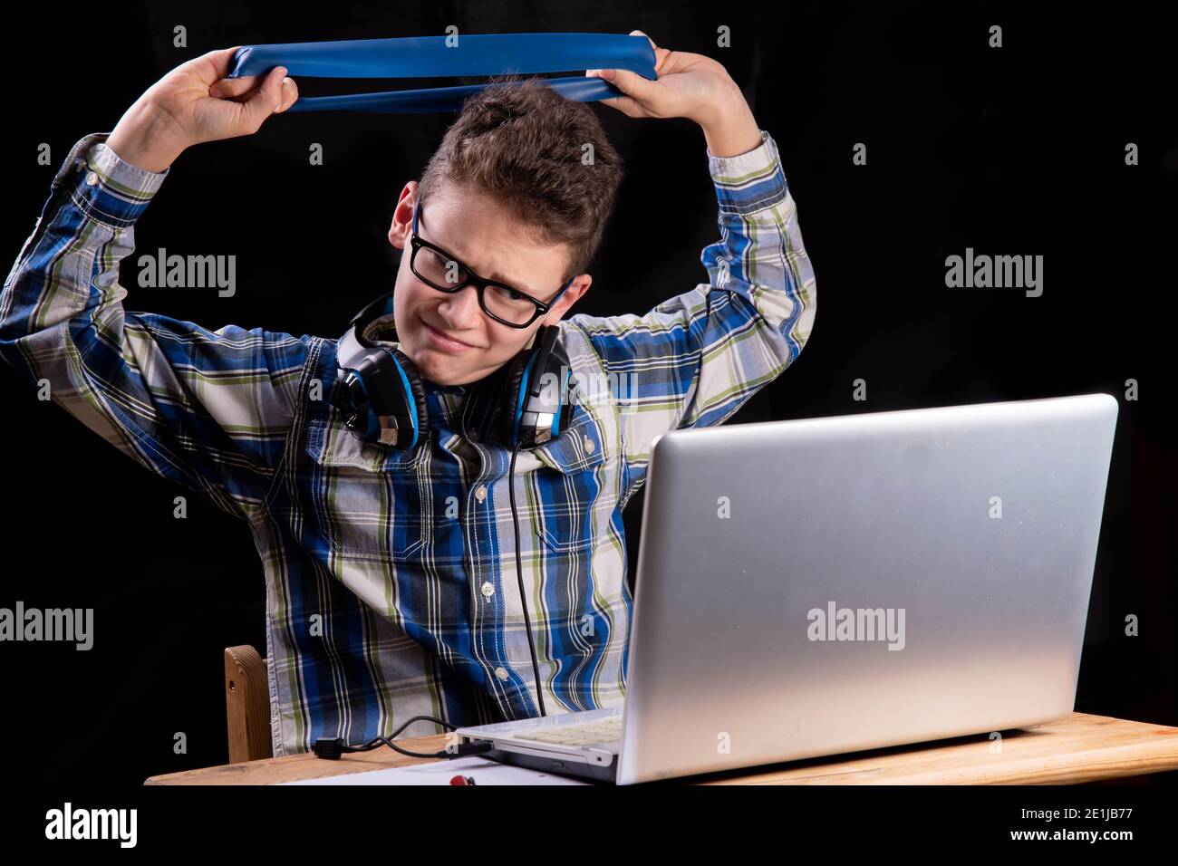 Stretching exercises on laptop homeschooling Stock Photo - Alamy
