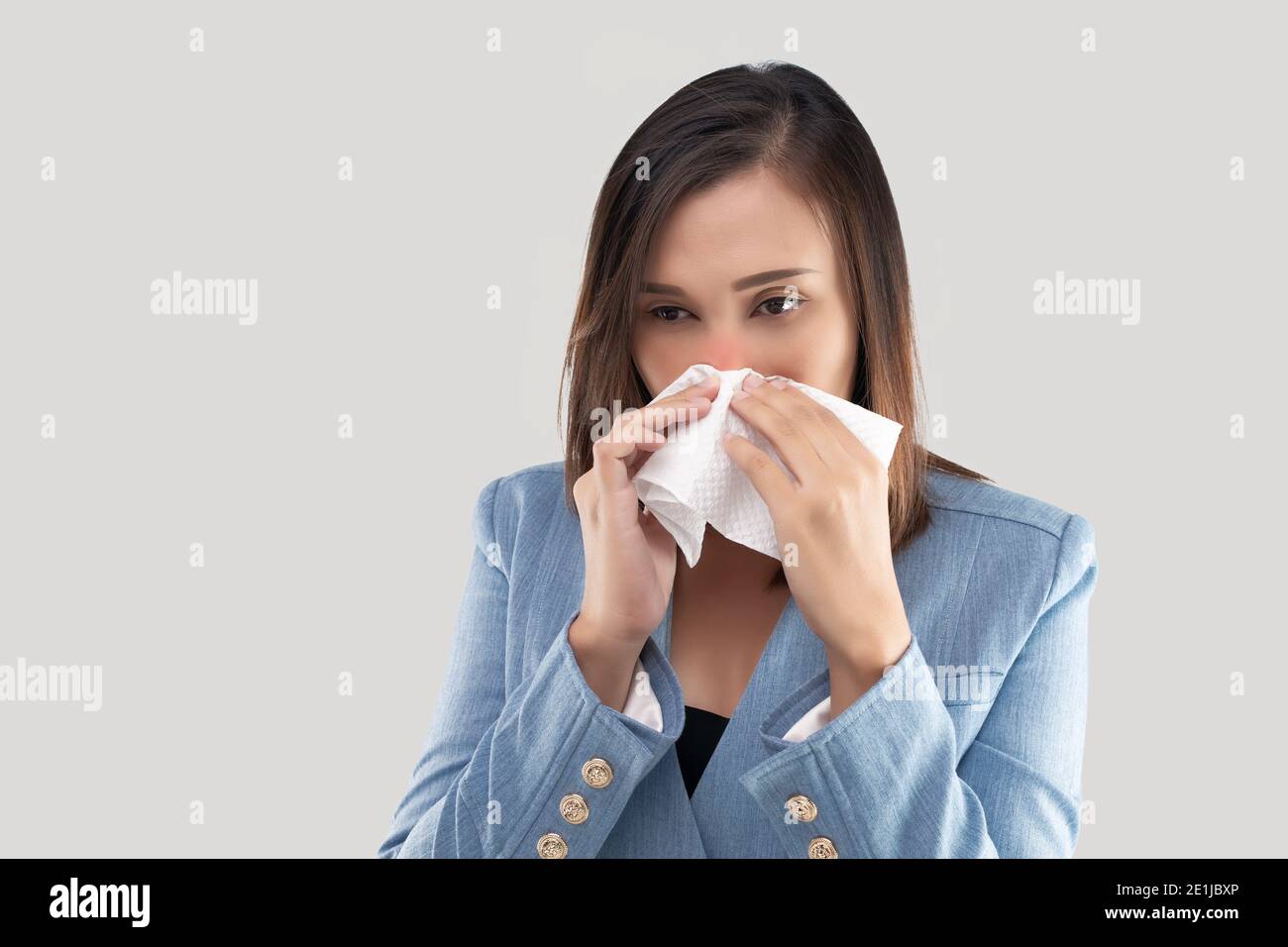 Businesswoman nose burning sensation because of the dust in the air on