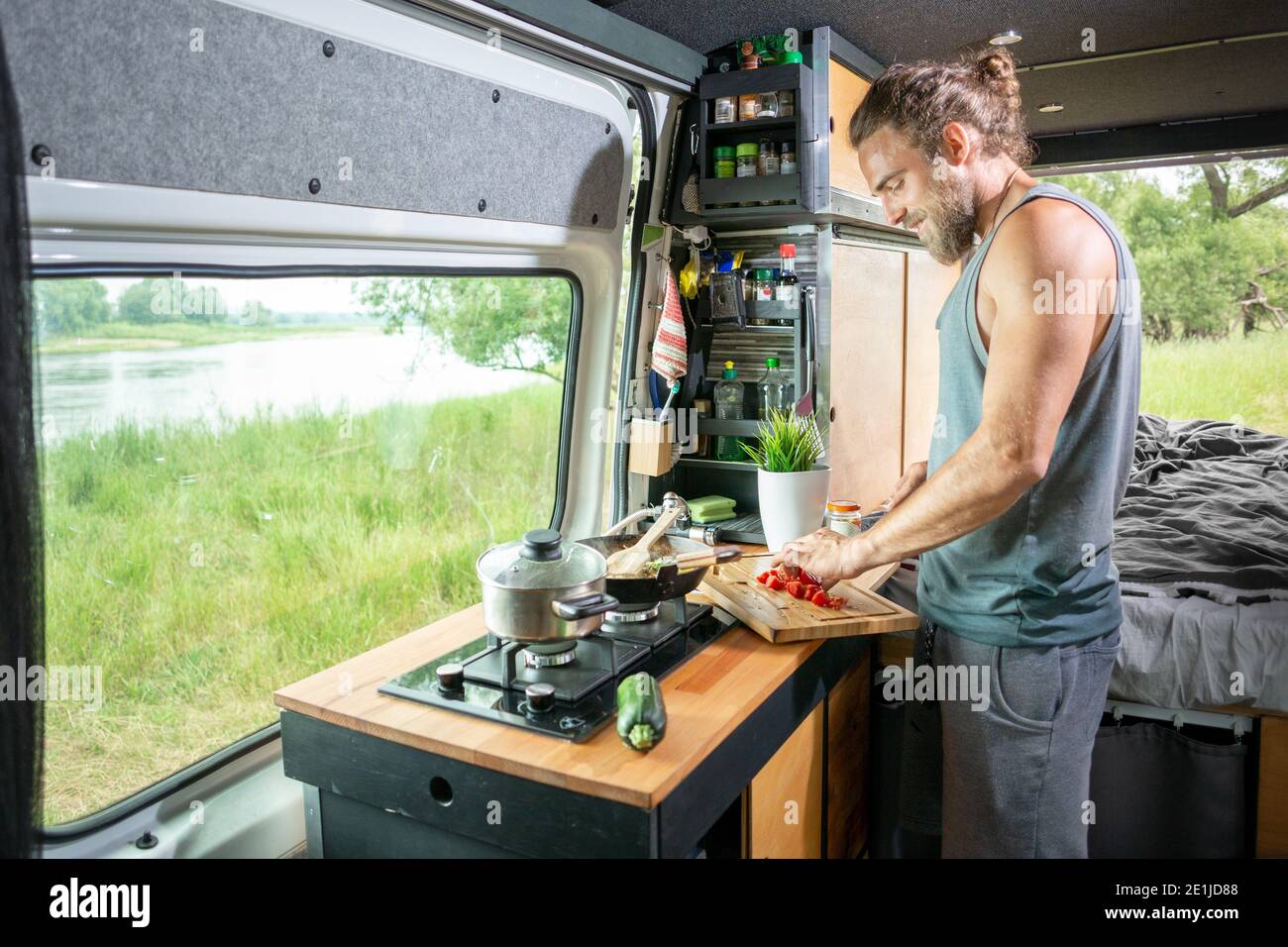 Young man living in a camper van Stock Photo