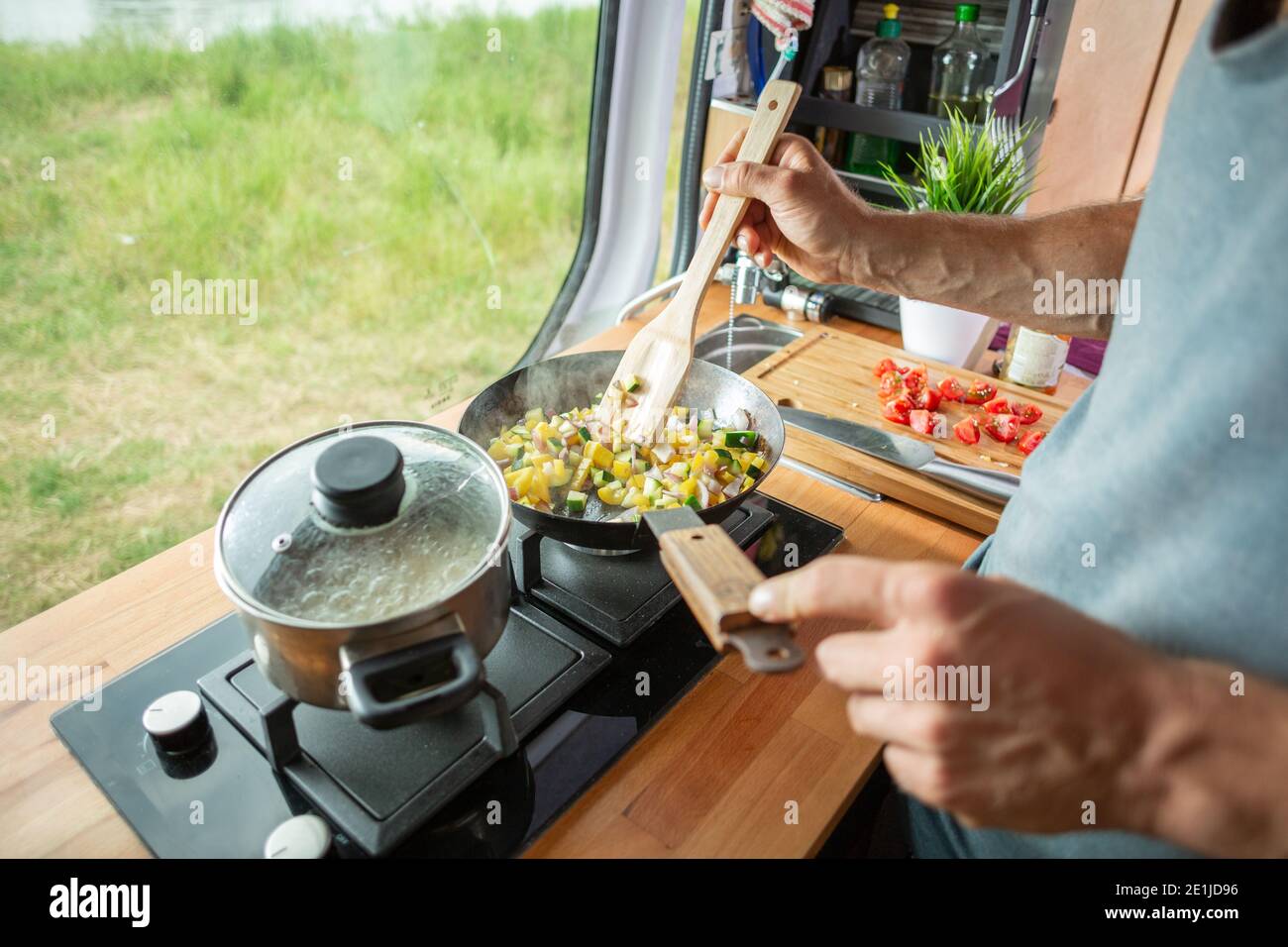 Cooking food on a stove inside a caravan Stock Photo