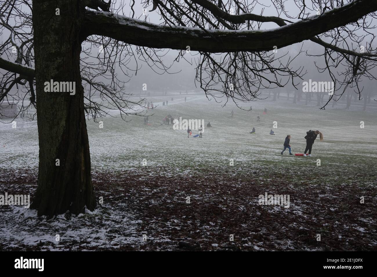 Glasgow, UK, 7 January 2021. People enjoy the fresh air, light snow and misty conditions, an escape from lockdown, with a trip to Queen's Park in the south of the city. Photo credit: Jeremy Sutton-Hibbert/Alamy Live News Stock Photo