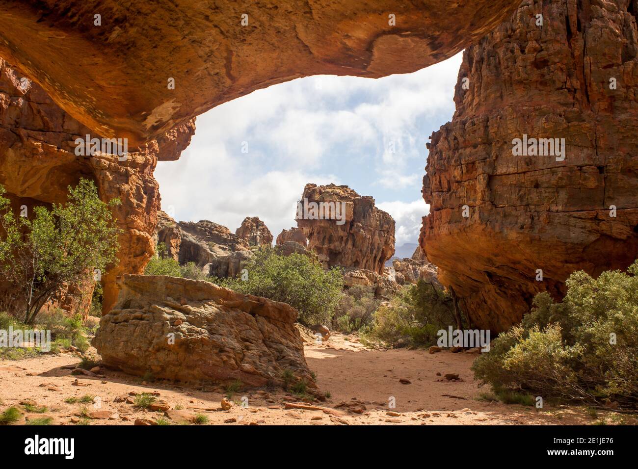 Looking through the strange,  rock formations, forming a natural doorway, at the Stadsaal Caves in the Cederberg Mountains of South Africa Stock Photo