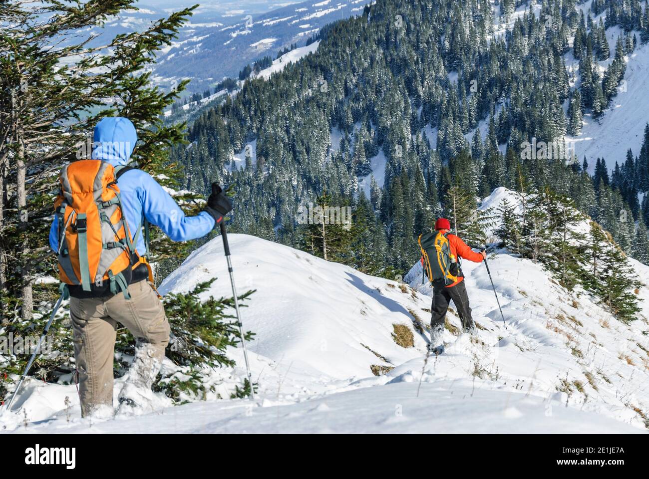 Hikers descending from mountain top Stock Photo