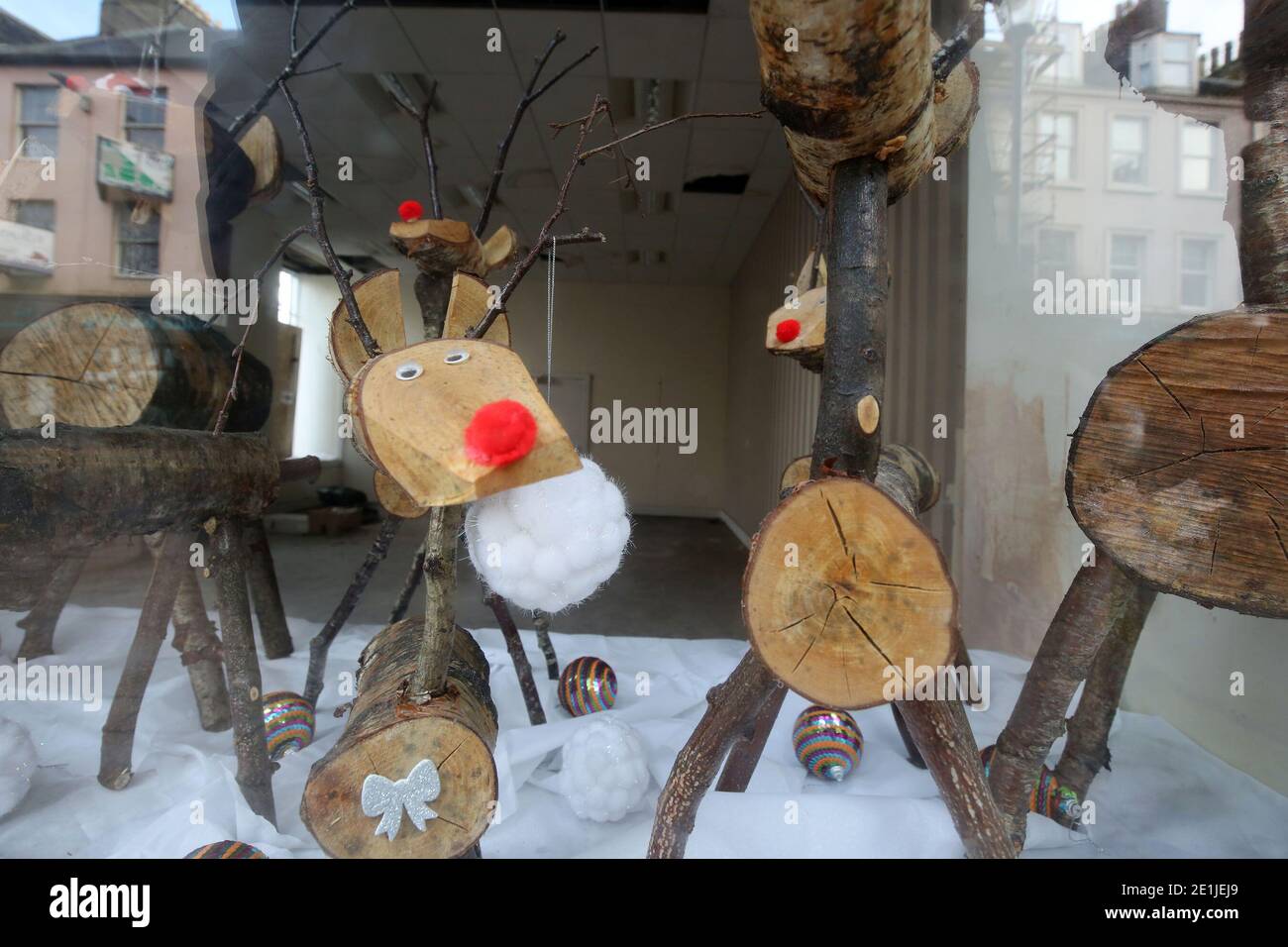 Ayr, Ayrshire, Scotland, UK. Wooden reindeer made from logs in shop window part of South Ayrshire Council's Winter Wonderland Stock Photo