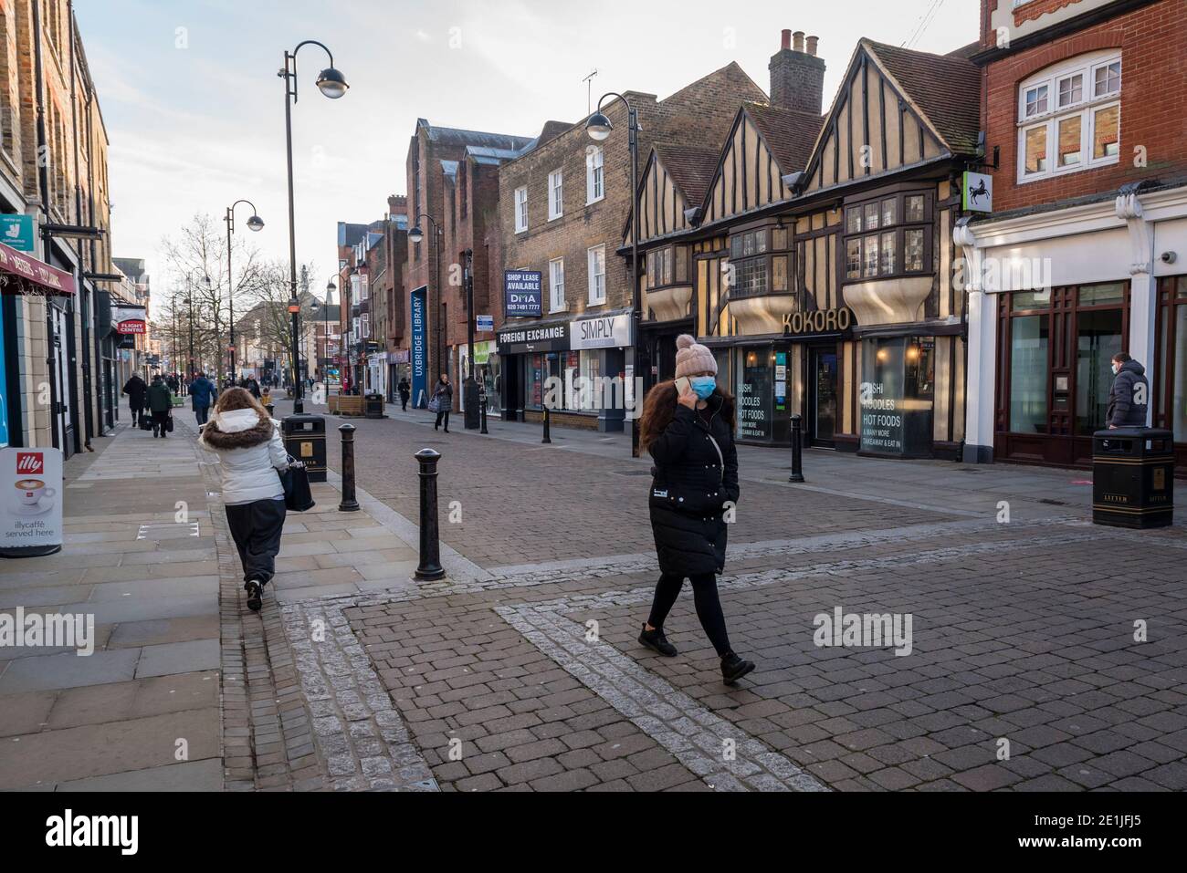 Uxbridge, UK.  7 January 2021. People in the high street in Uxbridge, north west London, on the morning that the third national lockdown came in to effect.  The UK government has imposed tougher restrictions in an effort to combat a recently discovered variant strain as the number of Covid-19 related deaths and coronavirus cases continues to increase.  Boris Johnson, Prime Minister, is MP for the constituency of Uxbridge and South Ruislip.  Credit: Stephen Chung / Alamy Live News Stock Photo