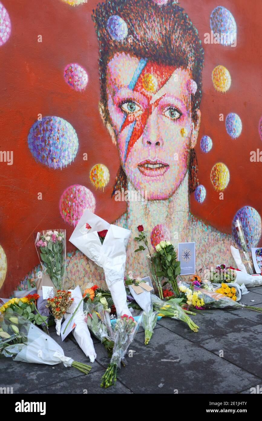 A graffiti of David Bowie as Ziggy Stardust in Brixton, London Since his death the mural has been the centre of a shrine in his memory. Stock Photo