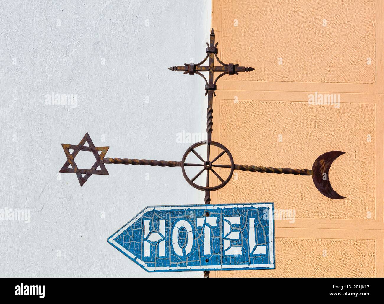 Ronda, Malaga Province, Andalusia, Spain.  Hotel street sign with Islamic, Jewish and Christian symbols which echo city history. Stock Photo