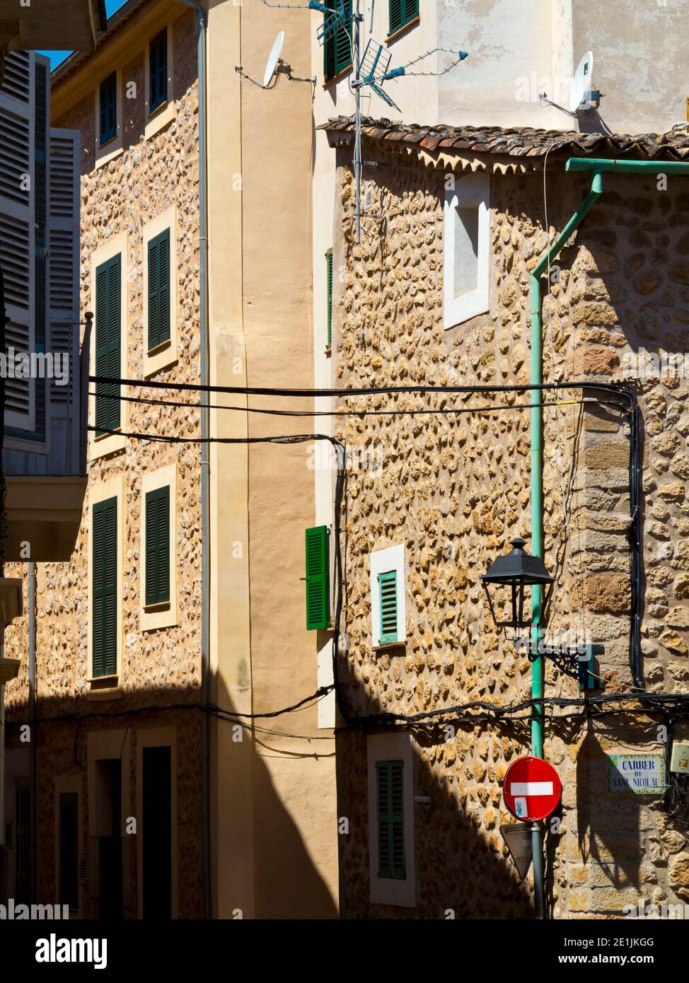 Street lamp and road signs on a typical narrow street in Soller a town on the north west coast of Mallorca in the Balearic Islands of Spain. Stock Photo