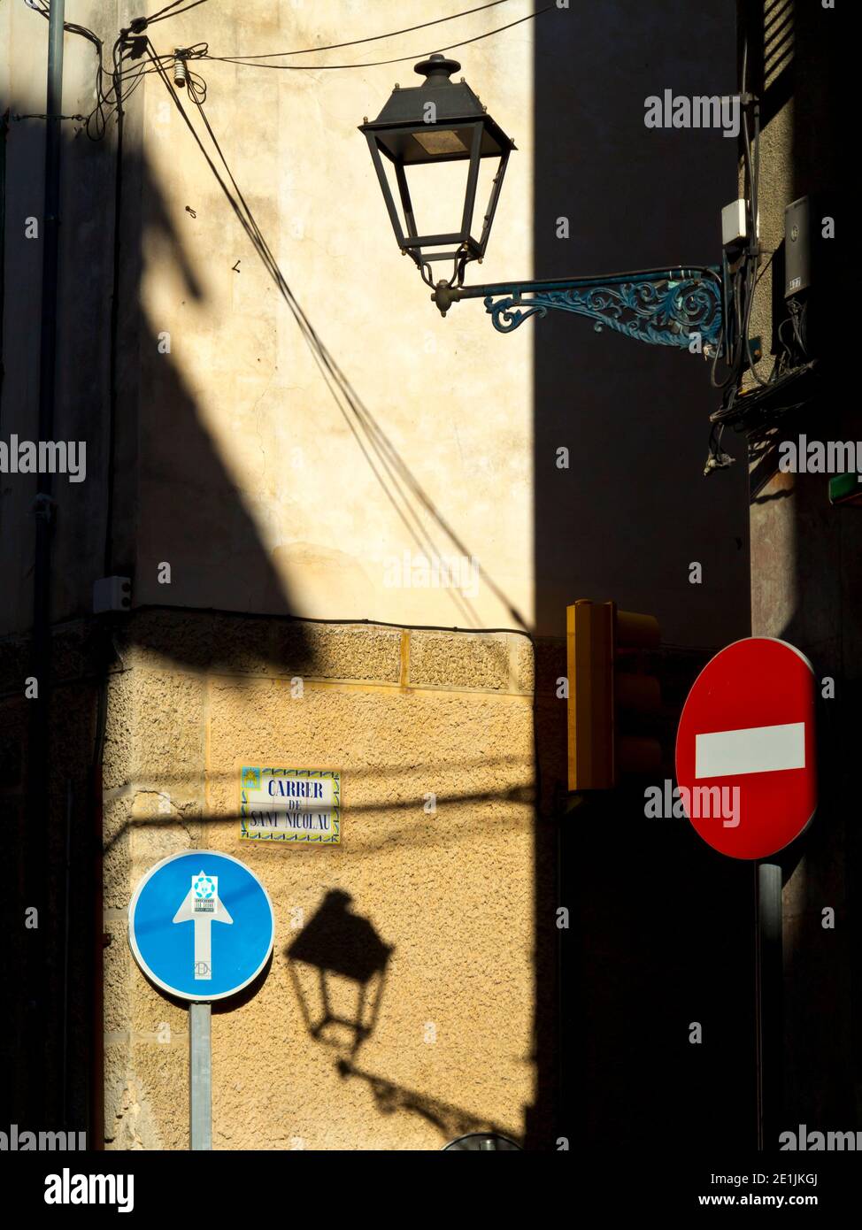 Street lamp and road signs on a typical narrow street in Soller a town on the north west coast of Mallorca in the Balearic Islands of Spain. Stock Photo