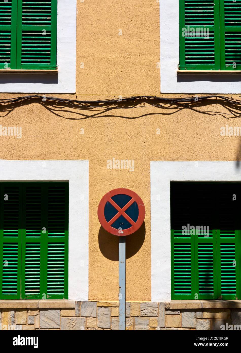No stopping or parking road sign in a typical narrow street in Soller a town on the north west coast of Mallorca in the Balearic Islands of Spain. Stock Photo