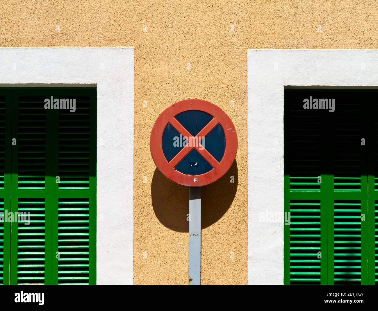 No stopping or parking road sign in a typical narrow street in Soller a town on the north west coast of Mallorca in the Balearic Islands of Spain. Stock Photo