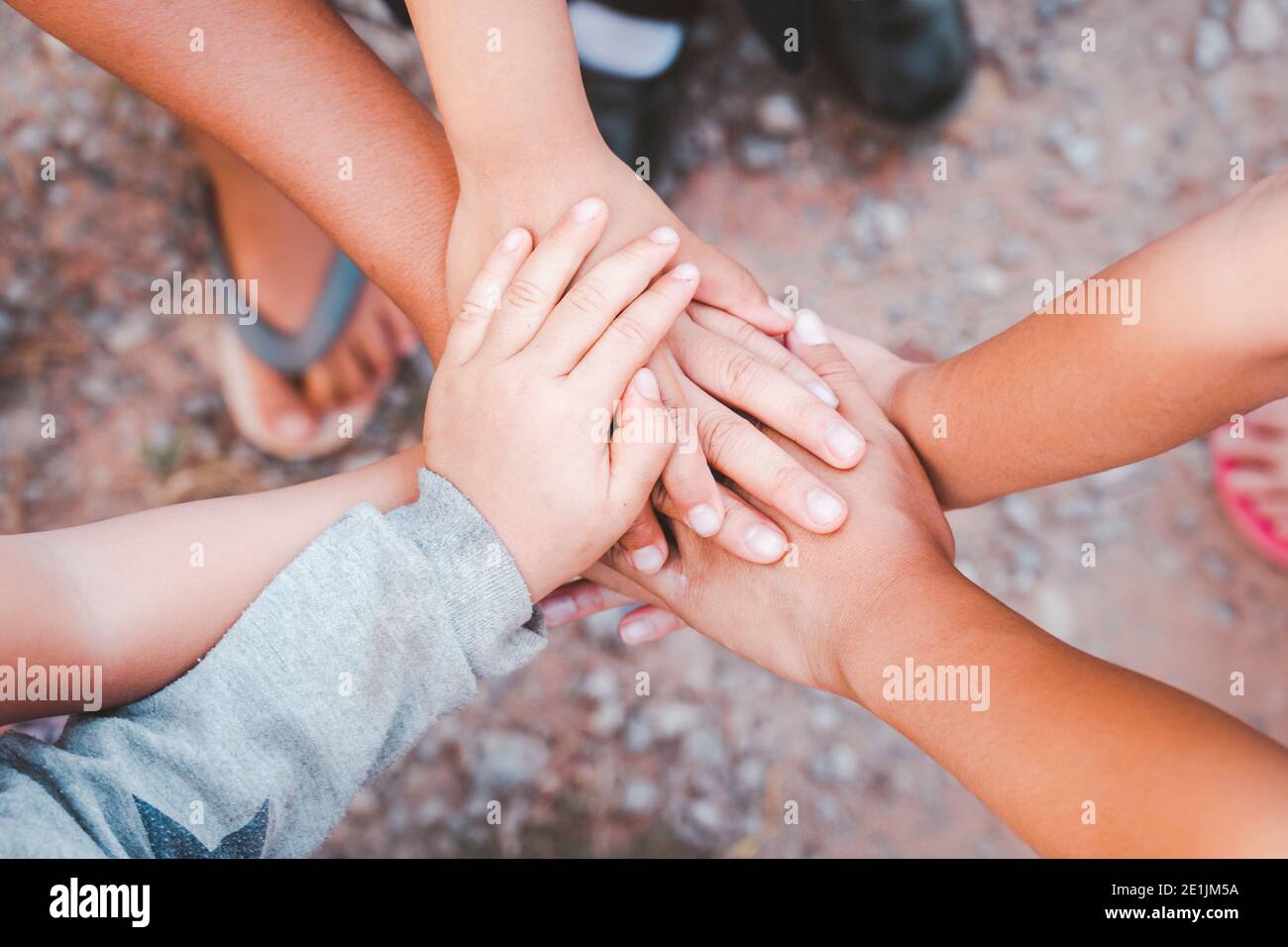 diverse hands joined together from child hand friendship Stock Photo