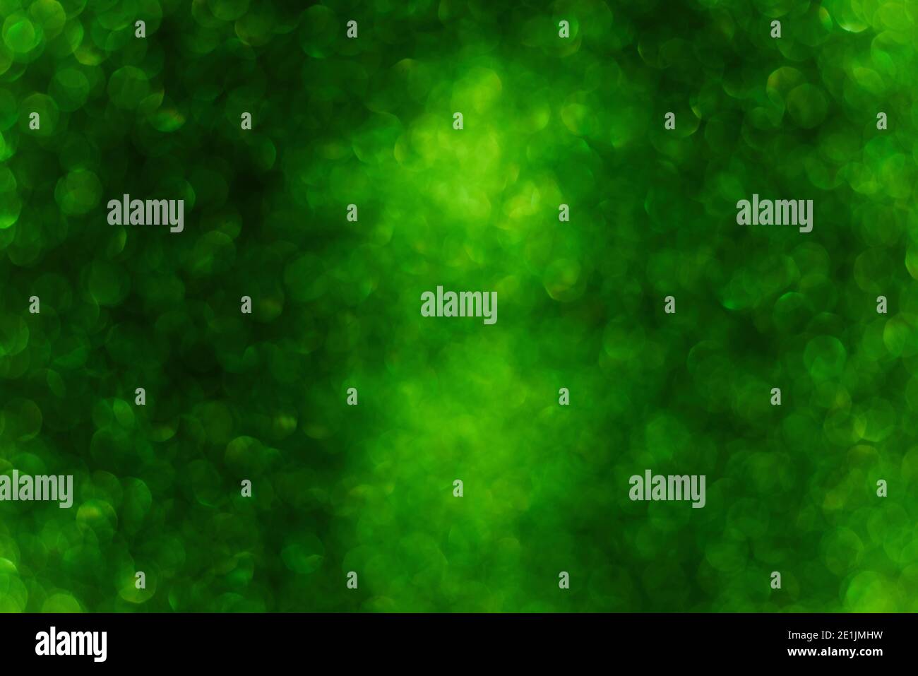 Blurred defocused background. Texture of green black bokeh. Template for St. Patrick's Christmas holiday greeting cards. Abstraction template. Copy sp Stock Photo
