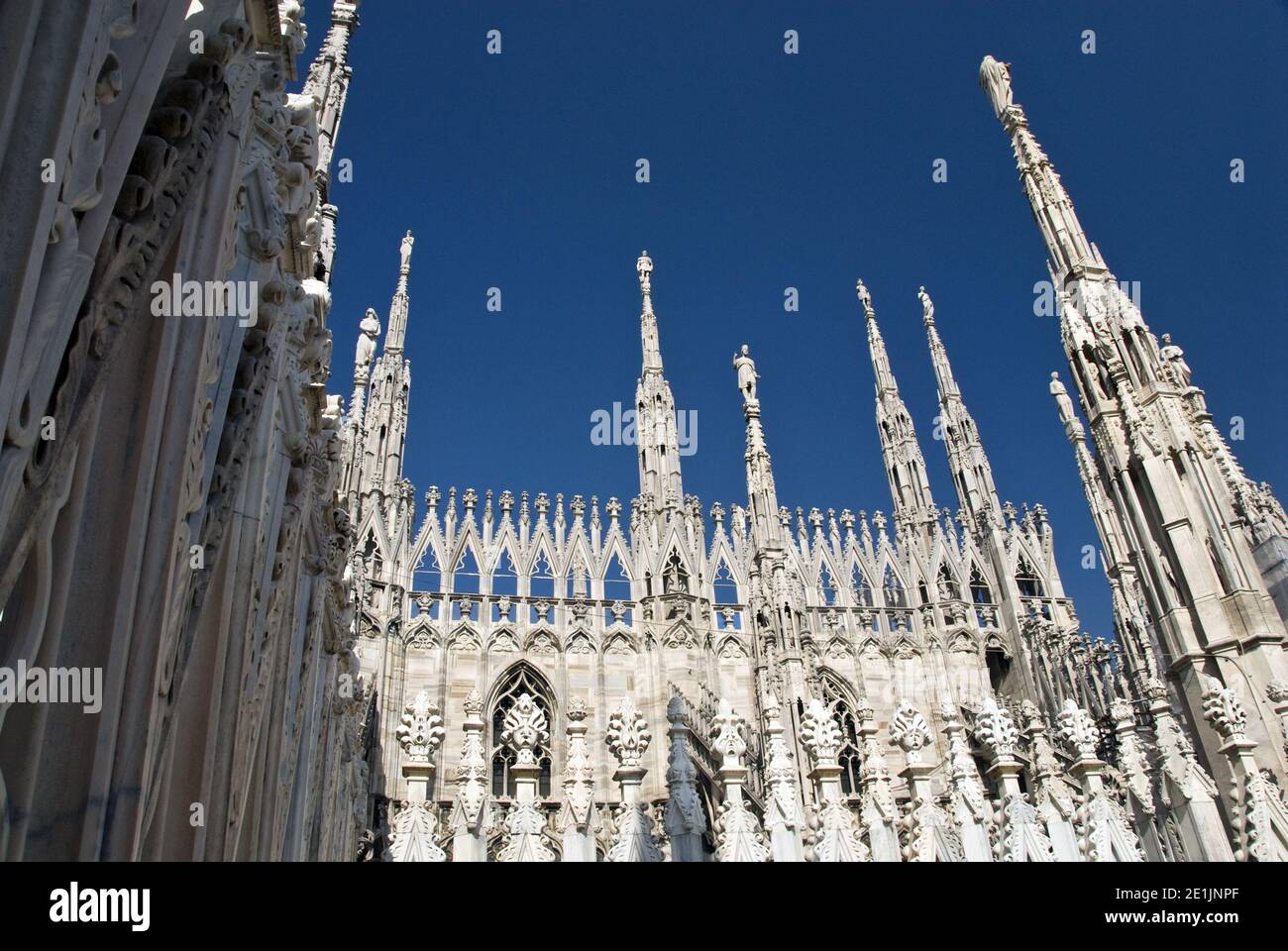 The Milan Cathedral (Duomo di Milano) is renowned for its openwork pinnacles and spires, set upon delicate flying buttresses. Stock Photo