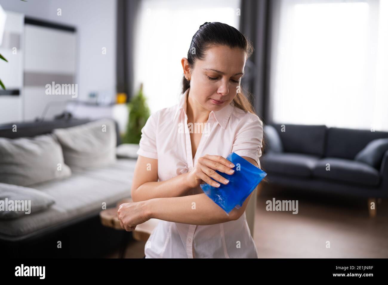 Ice Pack Cold Compress. Arm Joint Pain Stock Photo