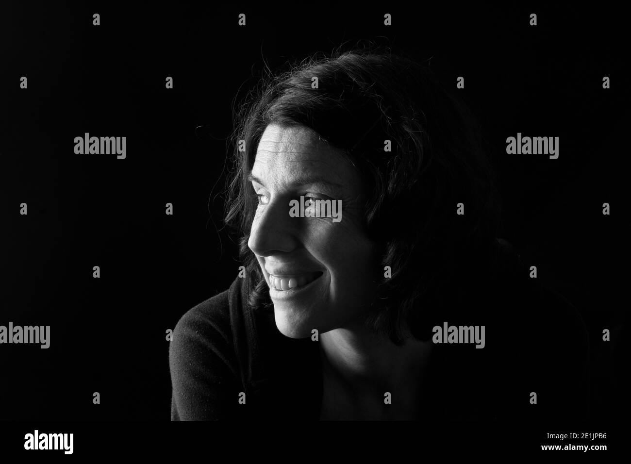 portrait of a woman on black background Stock Photo - Alamy