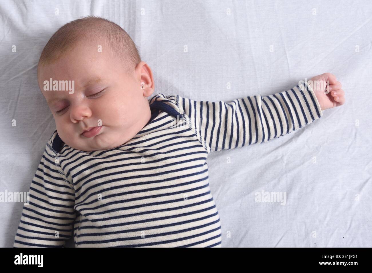 a baby sleeping in bed Stock Photo - Alamy