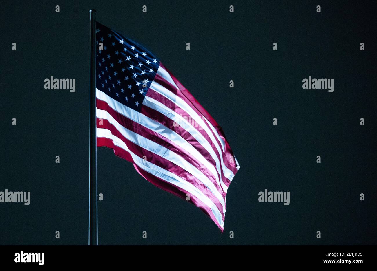 Berlin, Germany. 07th Jan, 2021. The United States flag flies atop the U.S. Embassy in Berlin. In response to the storm at the US Capitol in Washington, Berlin police have "adjusted" their protective measures for key buildings in the capital. Credit: Christophe Gateau/dpa/Alamy Live News Stock Photo