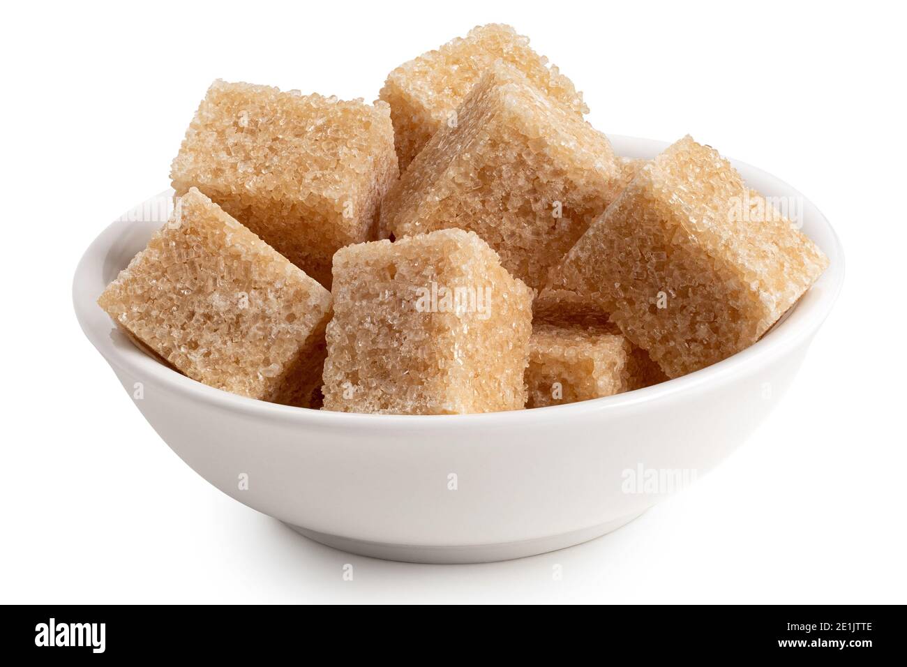 Brown sugar cubes in white ceramic bowl isolated on white. Stock Photo