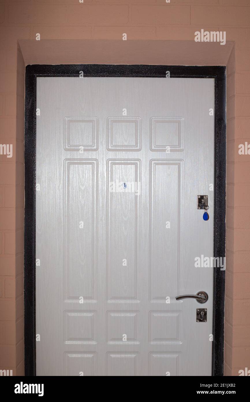 In A Corridor With Beige Walls A White Front Door With A Key Sticking Out The Interior Of The Living Quarters Stock Photo Alamy