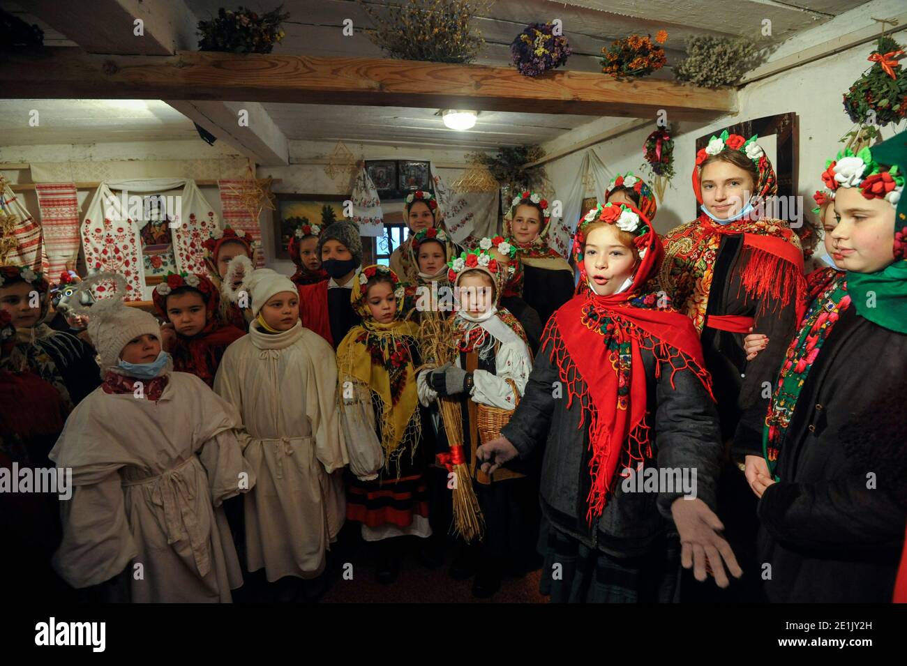 Ukrainian kids dressed in folk costumes singing Christmas songs during the Orthodox Christmas in Pirogovo village celebrated according to the old Julian calendar. Stock Photo