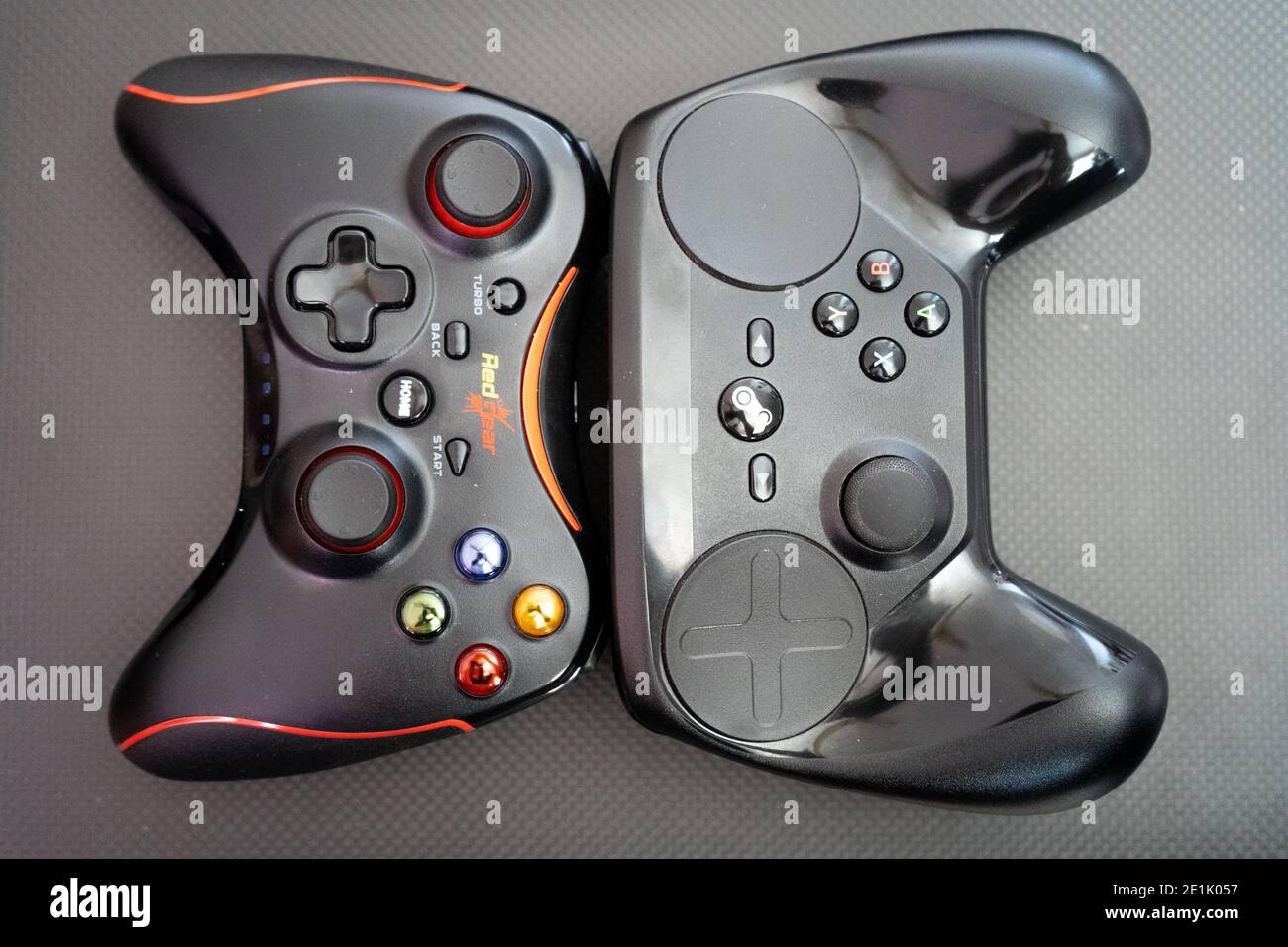 redgear vs the steam controller on a carbon fiber background showing  technology of inputs for computer gaming Stock Photo - Alamy